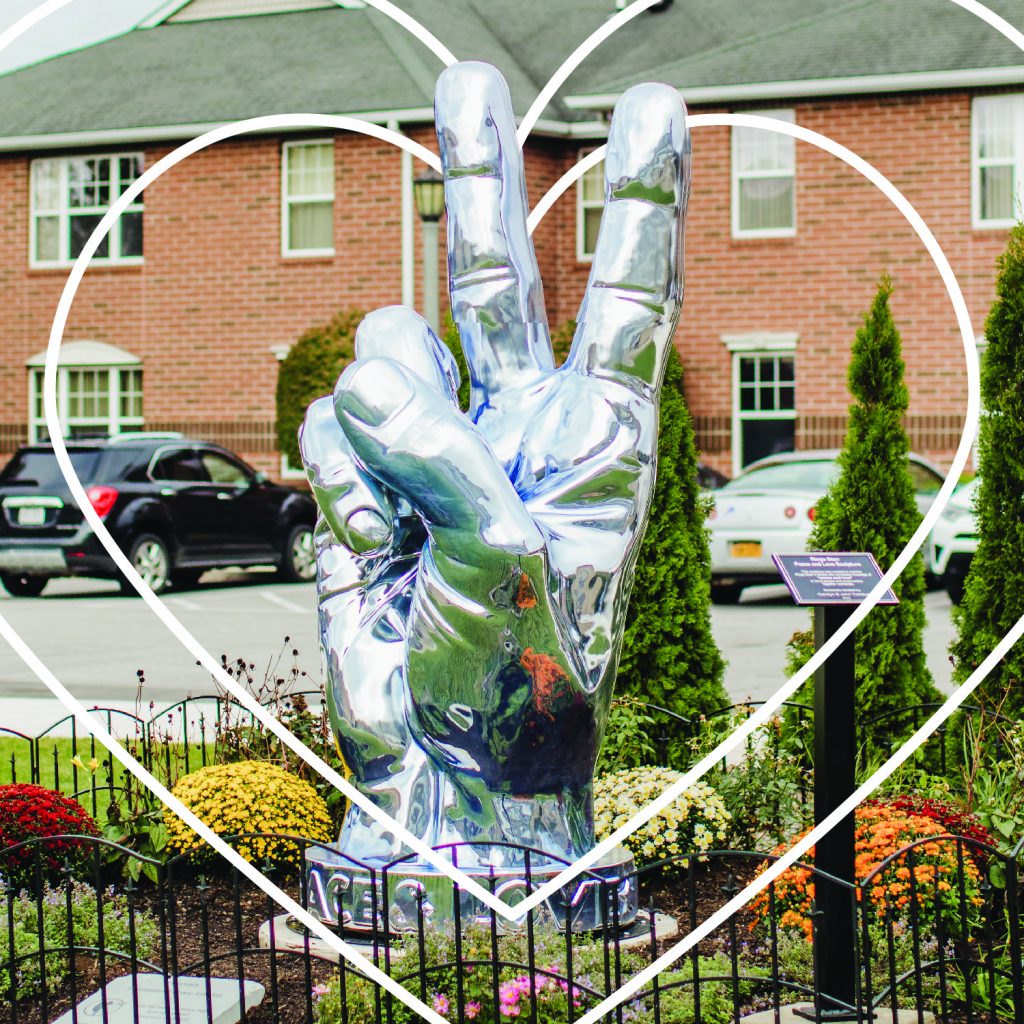 Chrome peace statue on campus