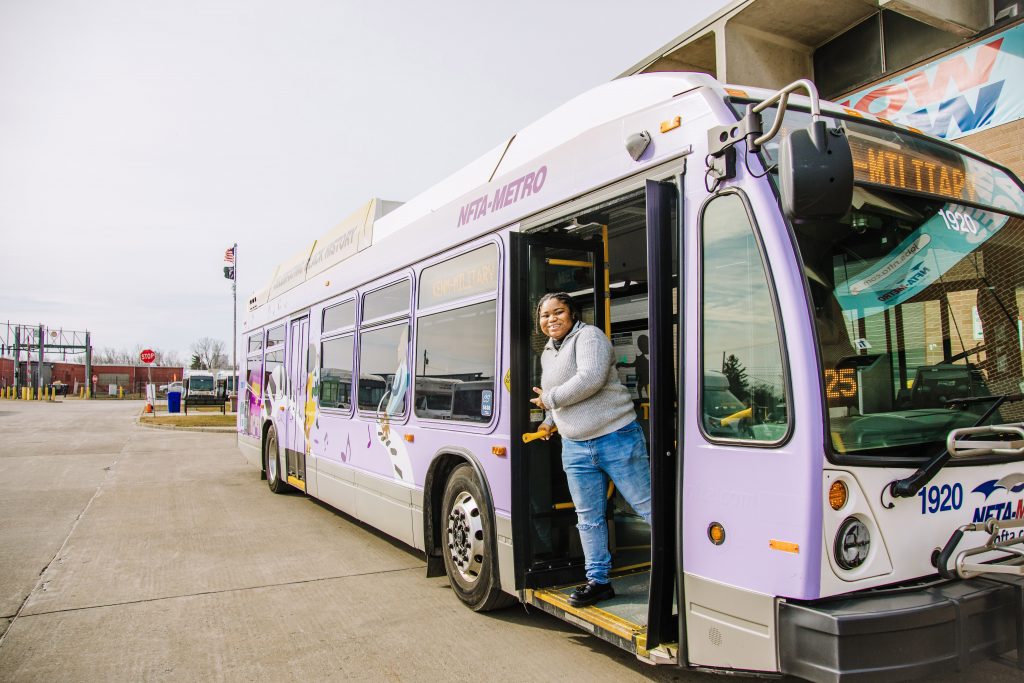 Amani Fanning ’24 getting of bus that features her design