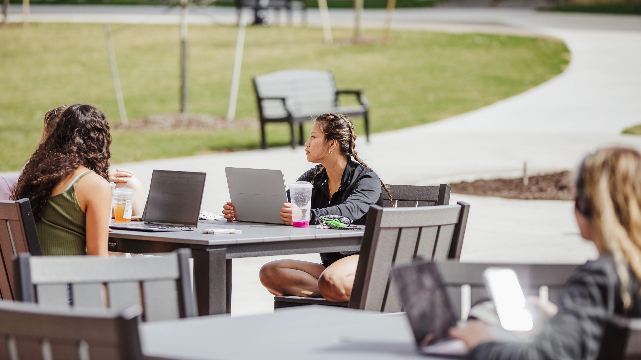 Students sitting outside at Saffrin Public Square using lapotps