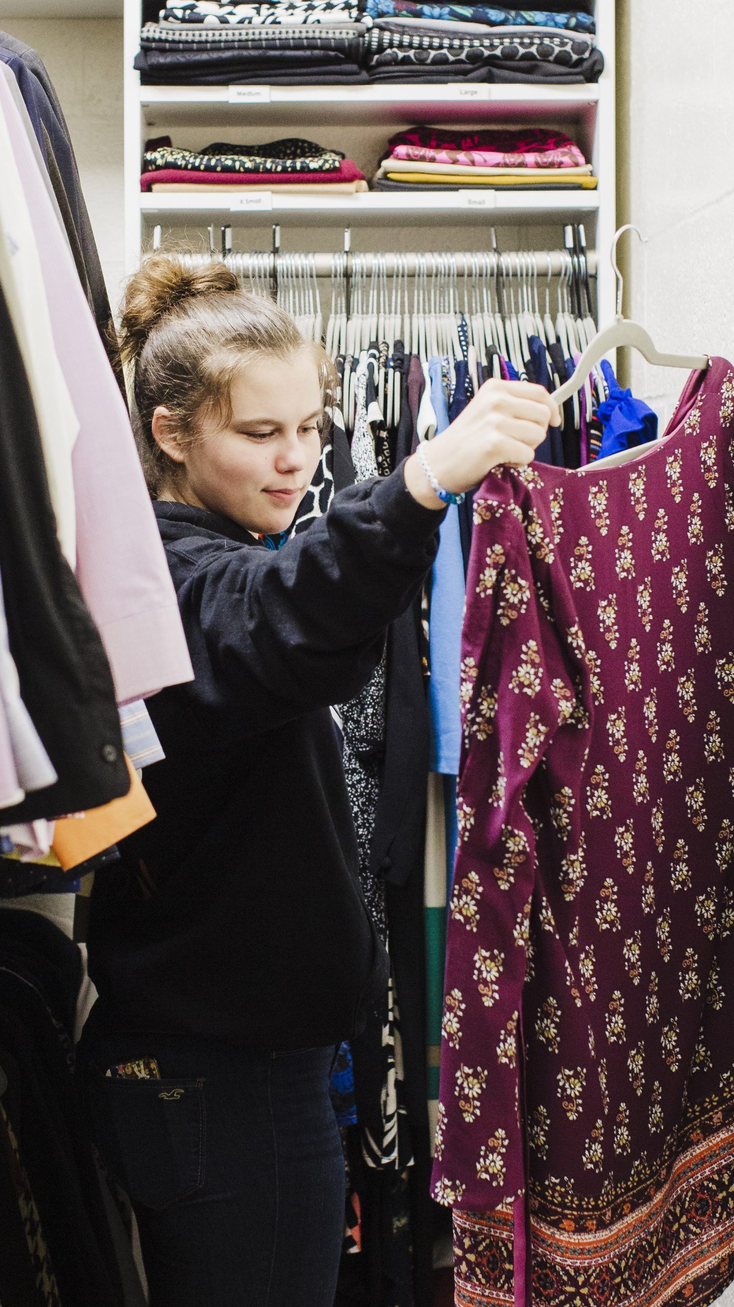 Student looking through Daemen Career Closet for clothes for an interview