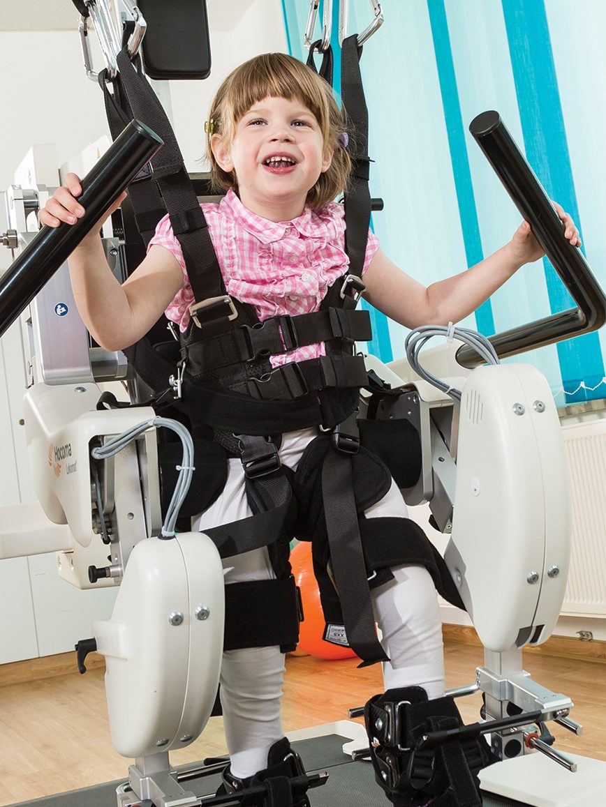 Young child walking using mobility device