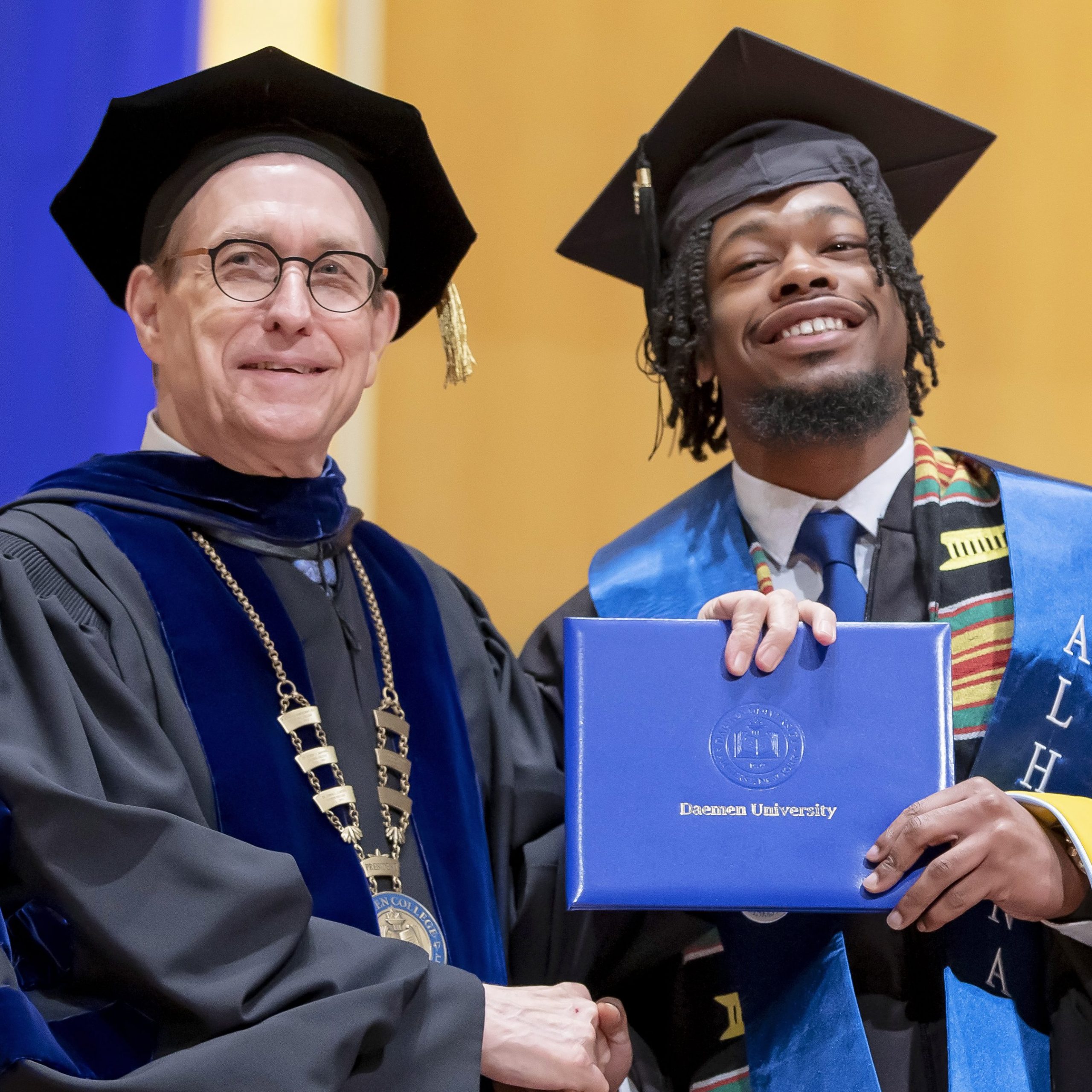 President Gary A. Olson and student at commencement