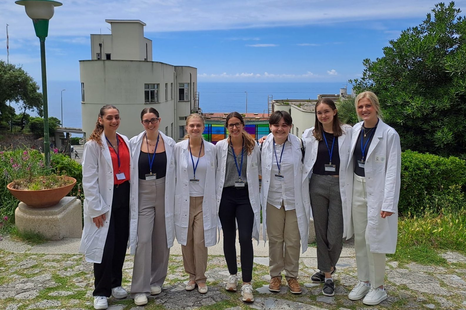 Study abroad students in white lab coats