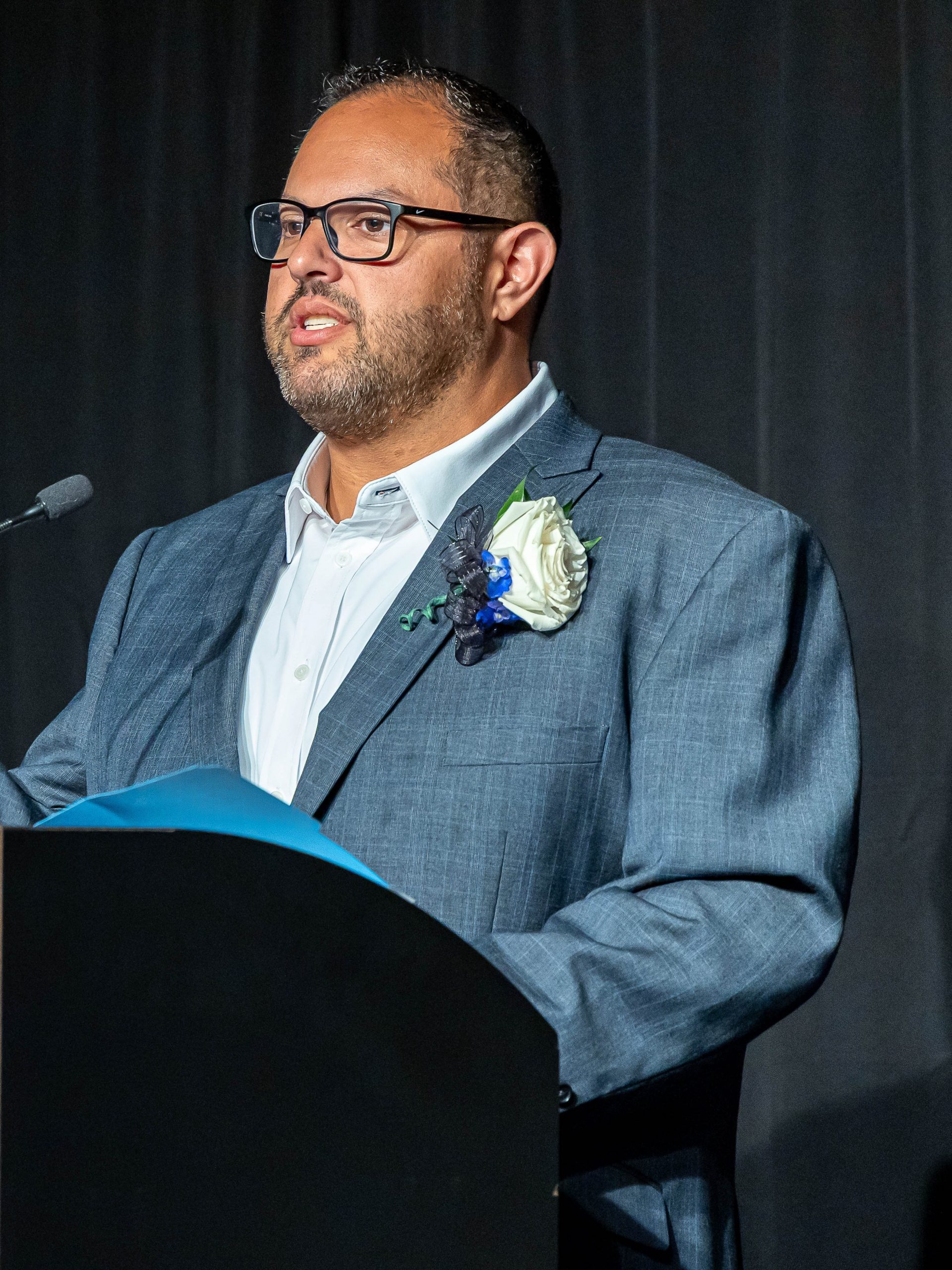 Geoffrey Abraskin standing at a podium speaking
