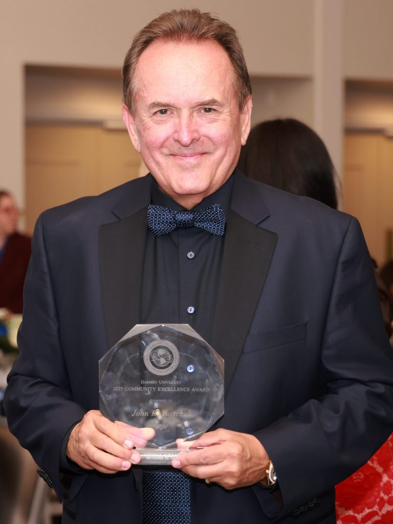 John Yurtchuk poses with the Community Excellence Award at Daemen’s Annual Scholarship Gala