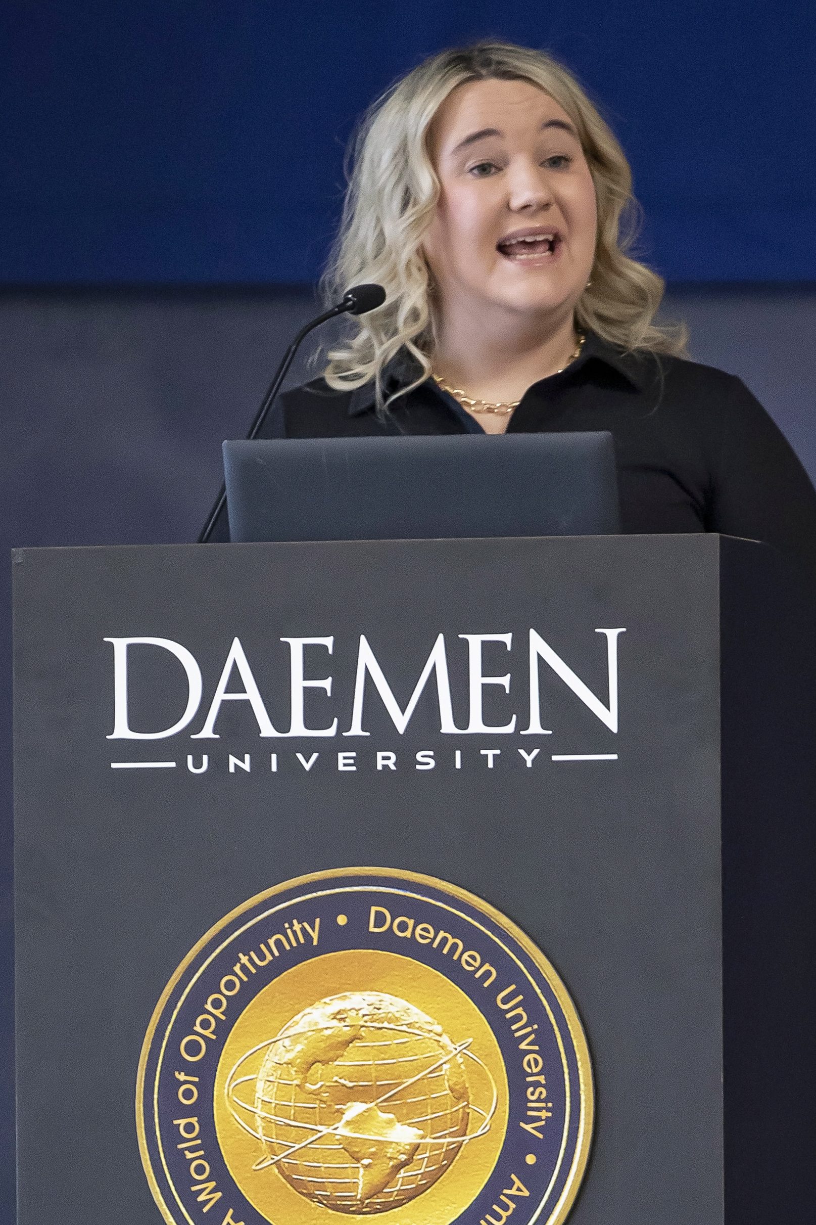 Alumni Sarah Rodman ’13 speaking from the Daemen podium